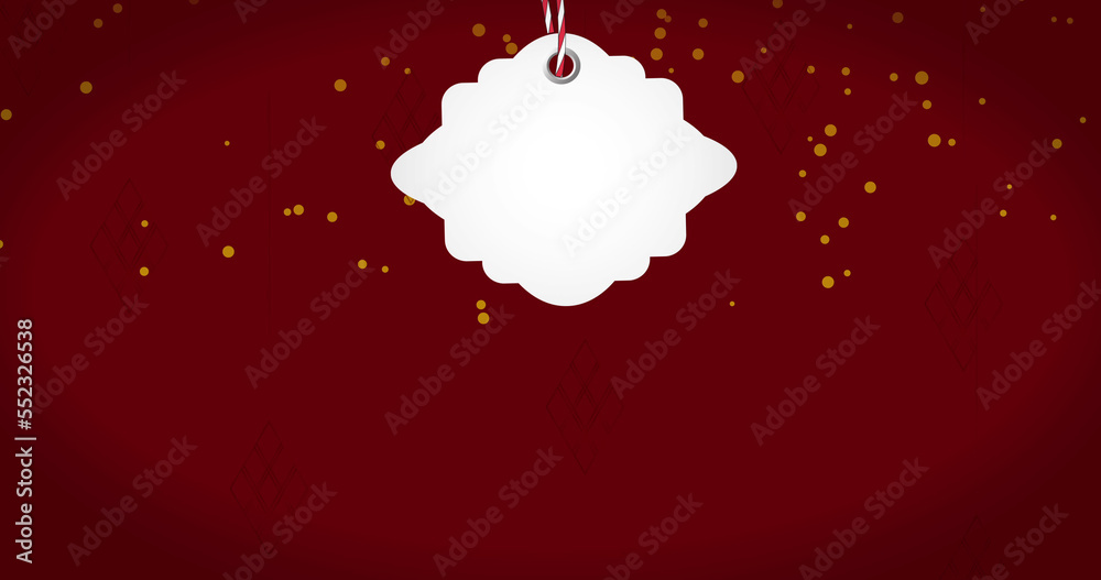 Image of gift tag with copy space over christmas baubles and light spots on red background