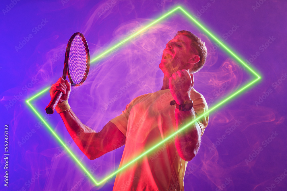 Caucasian tennis player screaming and holding racket by illuminated rectangle on purple background