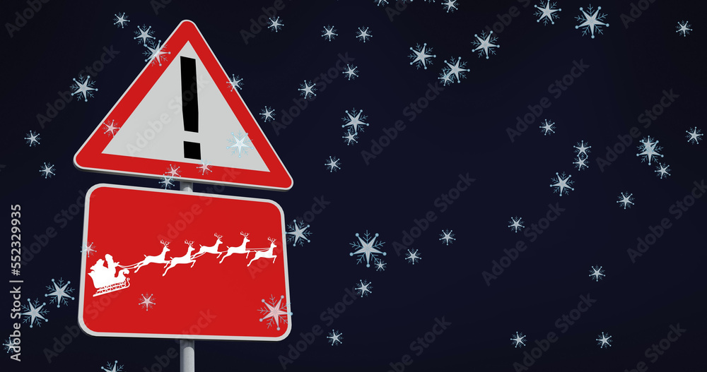 Image of snow falling over christmas road sign on black background