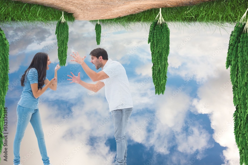 Caucasian couple arguing against upside down trees and and blue sky with copy space