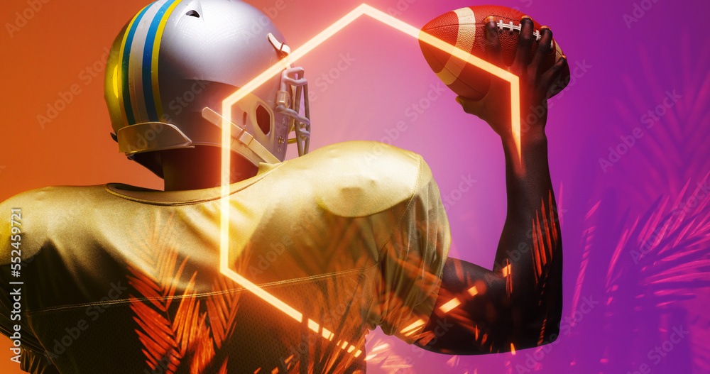 Rear view of american football player holding ball by illuminated hexagon and plants, copy space