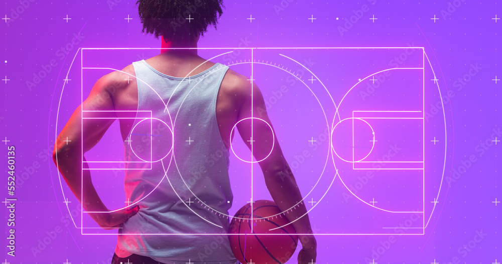 Composite of illuminated basketball court and plush signs over rear view of biracial man with ball