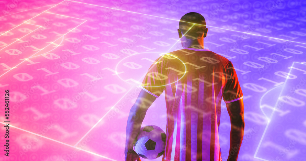 Rear view of african american male player with ball and illuminated soccer field over binary codes