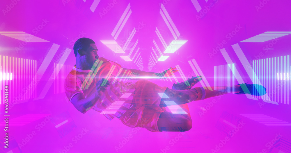 African american male soccer player jumping and kicking over illuminated lines and abstract patterns