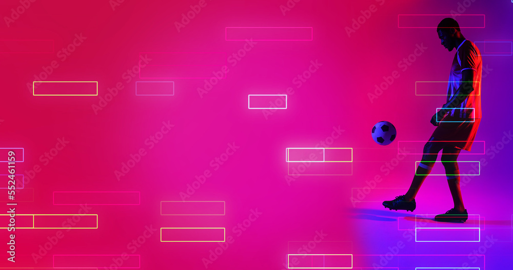 Side view of african american male player playing with soccer ball by illuminated rectangles