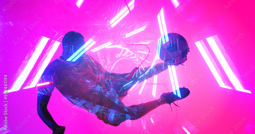 African american male player jumping and kicking ball over illuminated lines on pink background