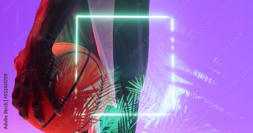 Multiple exposure of african american basketball player holding ball over plants with square neon