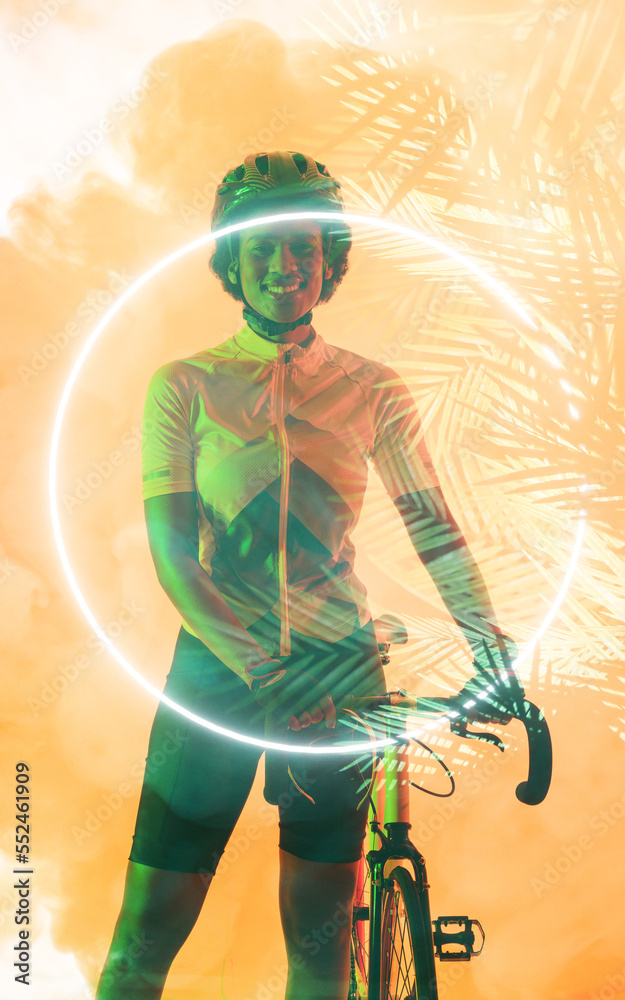 Multiple exposure of smiling young african american female cyclist over leaf pattern