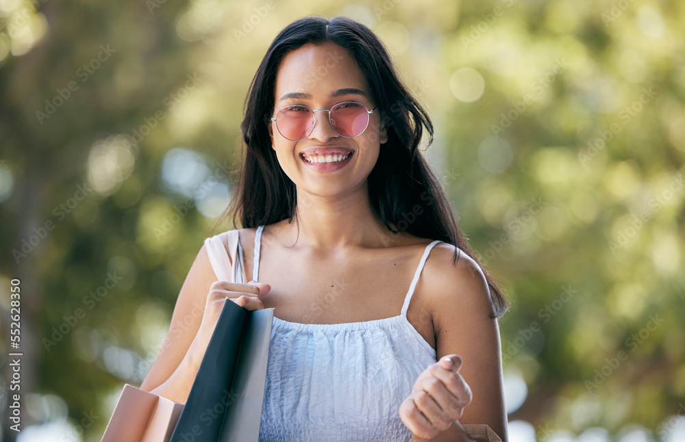 Woman, portrait and shopping with shopping bag outdoor, fashion with designer brand and happy with d