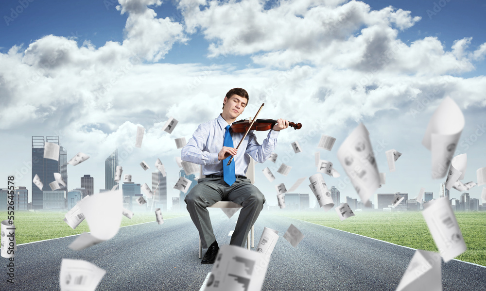 young businessman playing violin