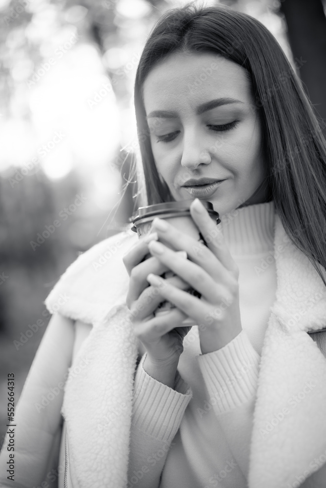 Young stylish lady portrait with autumn background. Elegant pretty woman lifestyle.