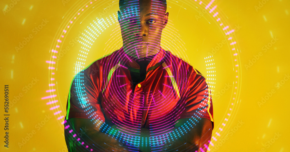 Serious african american rugby player standing over illuminated circles on yellow background