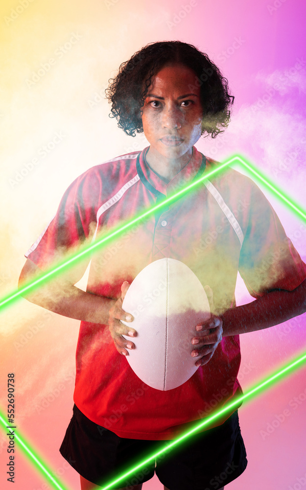 Composite of biracial female rugby player holding ball and standing over illuminated rectangle