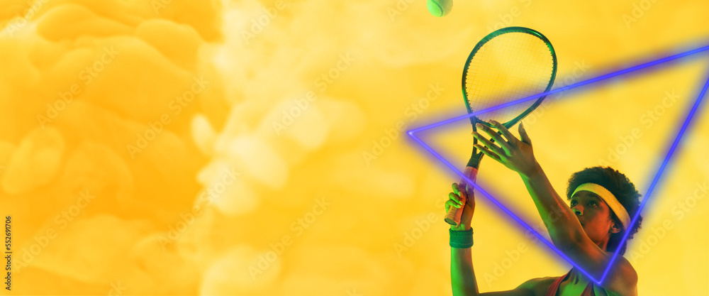 African american female player hitting ball with racket by illuminated triangle on smoky background