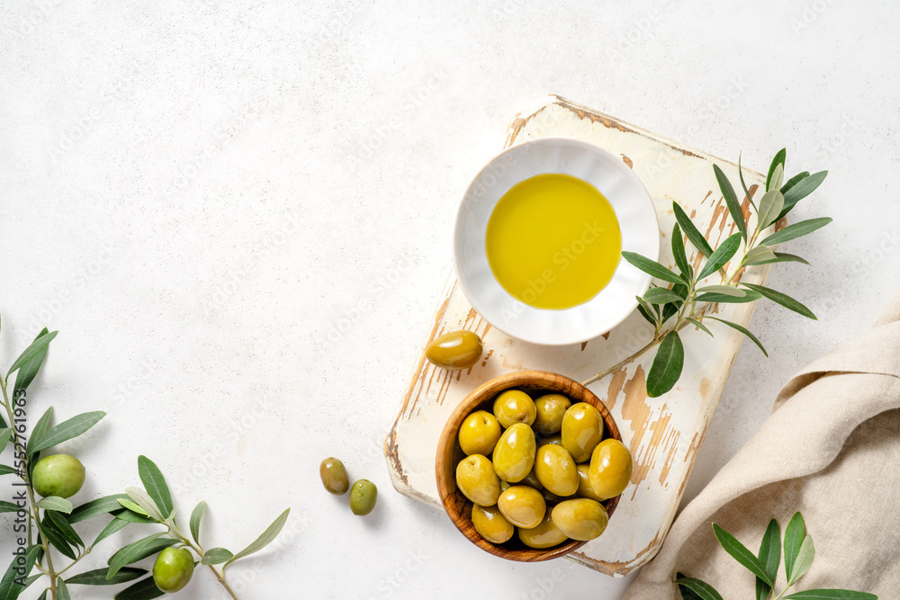 Fresh olives in bowl on white wooden board. Mockup for package. Copy space.