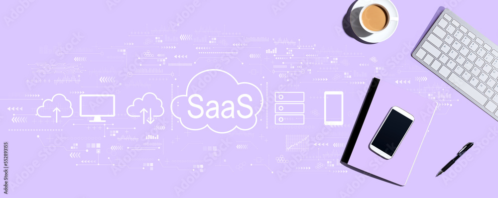 SaaS - software as a service concept with a computer keyboard and office items