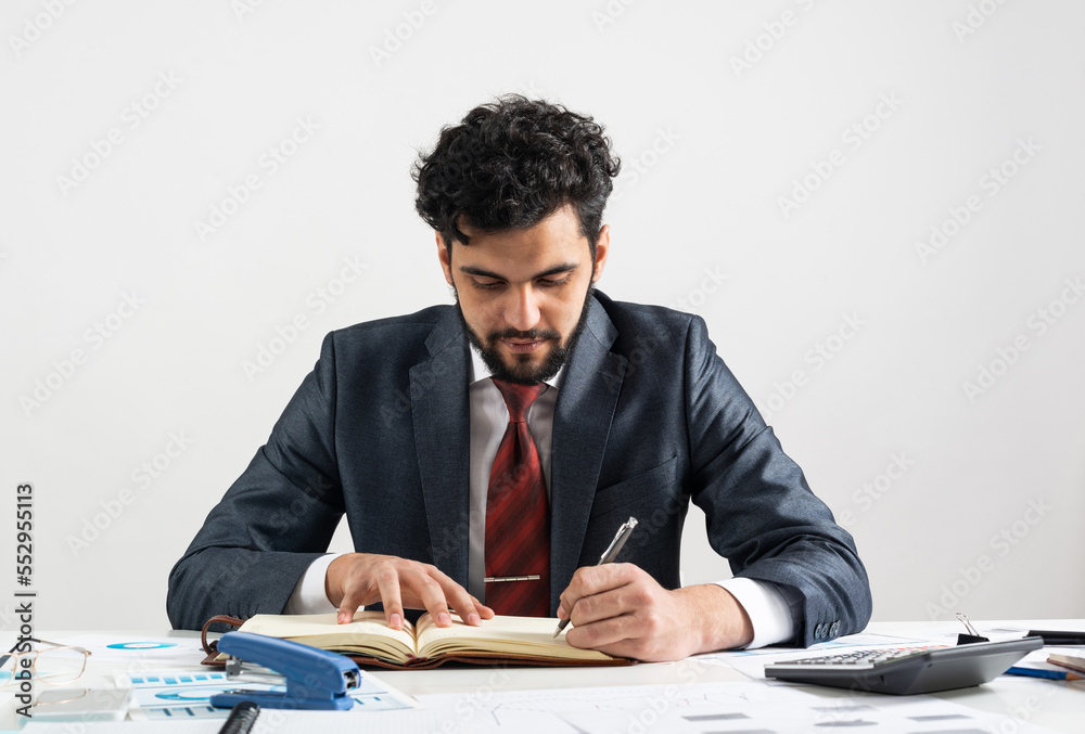 Arab businessman calculating budget at office desk