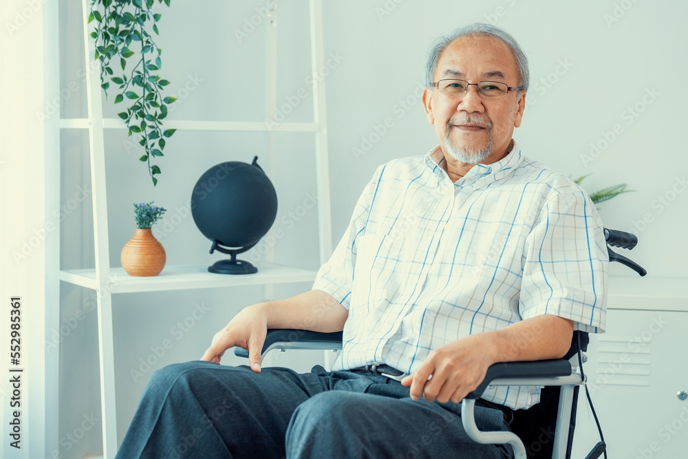 Portrait of a contented elderly man in sitting on a wheelchair at home. Senior person in nursing hou