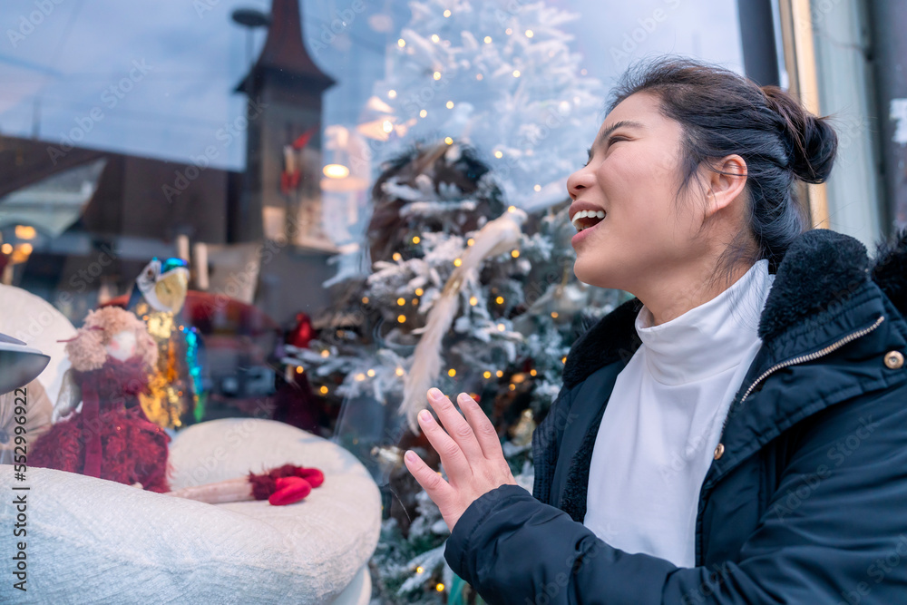 smiling cheerful happiness asian female woman wear winter cloth enjoy looking at shopfront window di