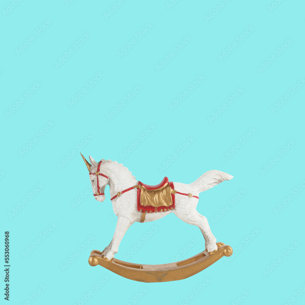 Rocking horse unicorn toy vintage childhood item isolated on blue background with shadow. Child memo