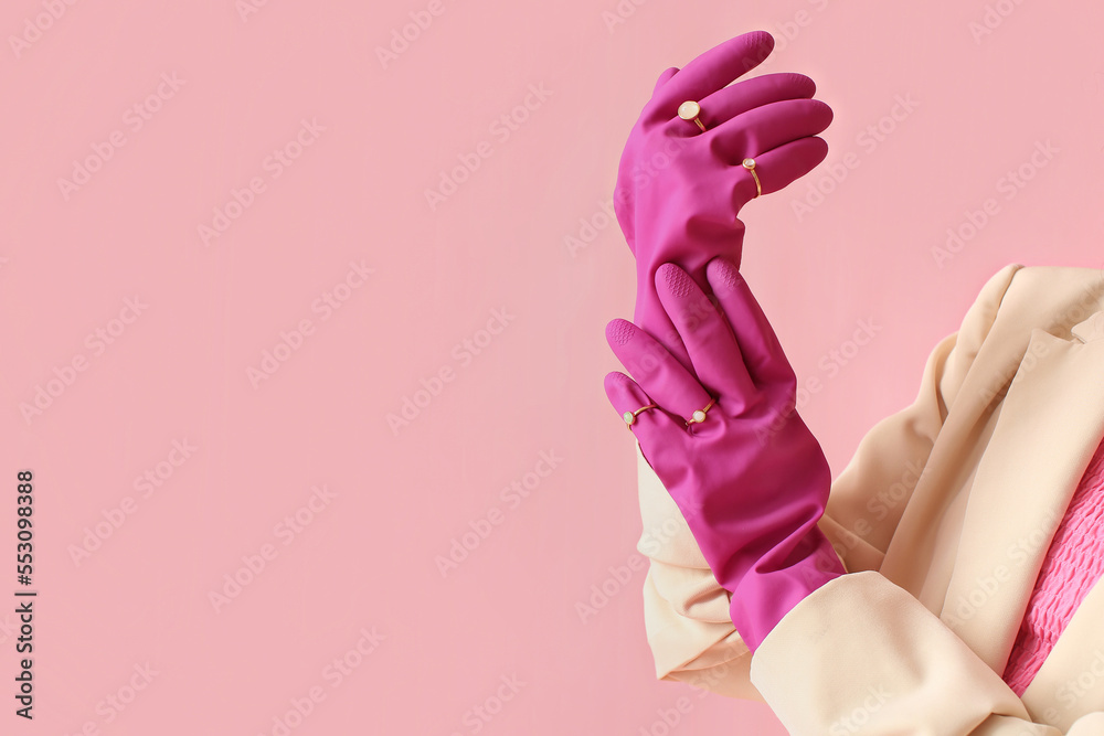 Female hands in rubber gloves and jewelry on color background, closeup