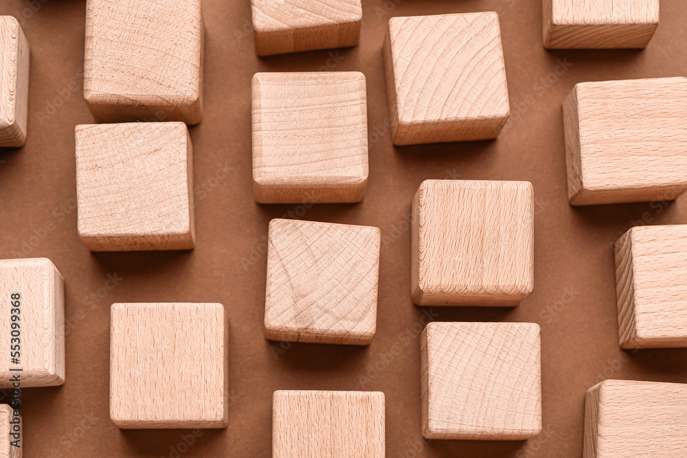 Wooden cubes on brown background