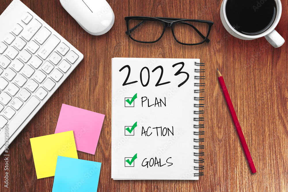 2023 Happy New Year Resolution Goal List and Plans Setting - Business office desk with notebook writ