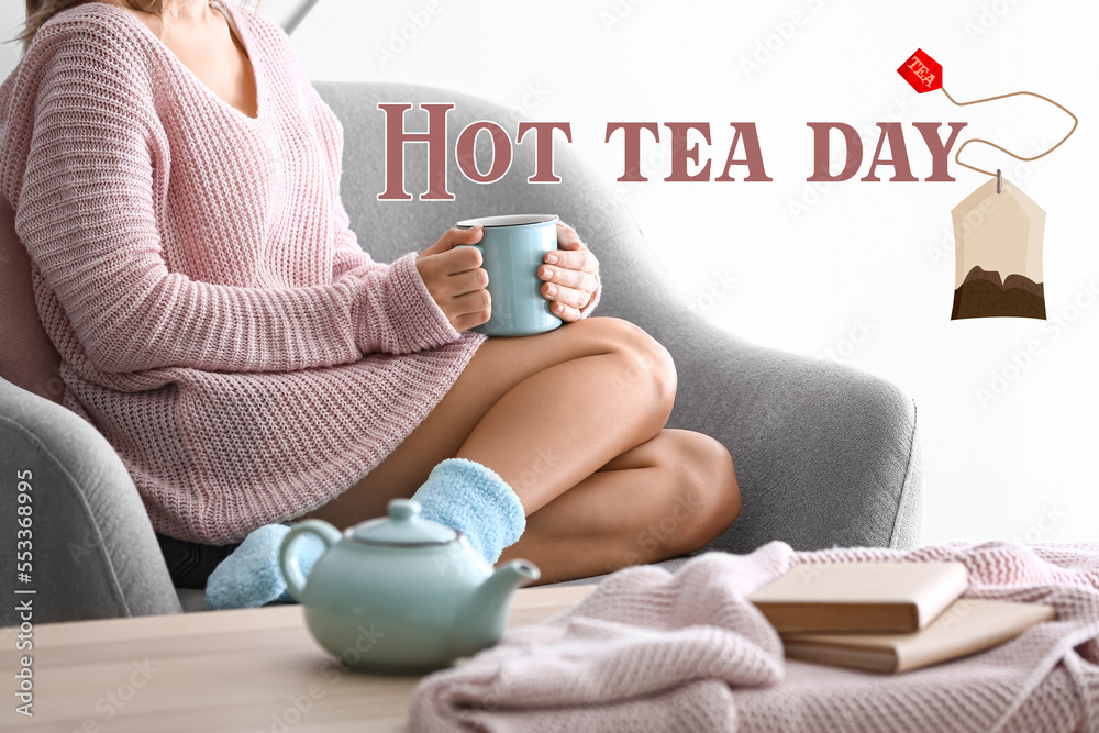 Young woman drinking aromatic beverage at home. Hot Tea Day