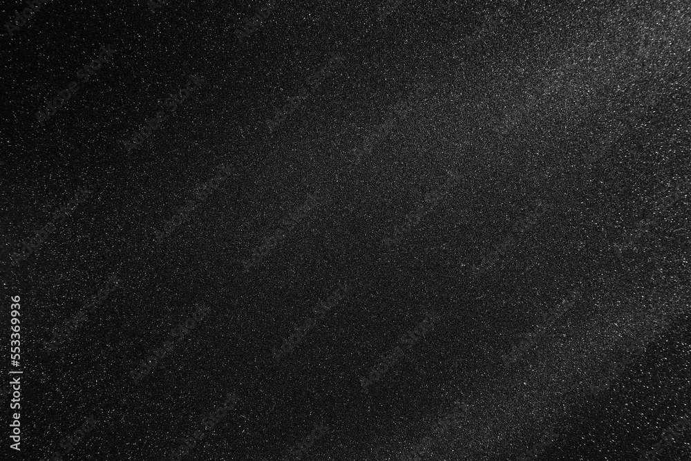 Black texture with white speckles as background