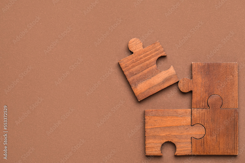 Combined pieces of puzzle on brown background