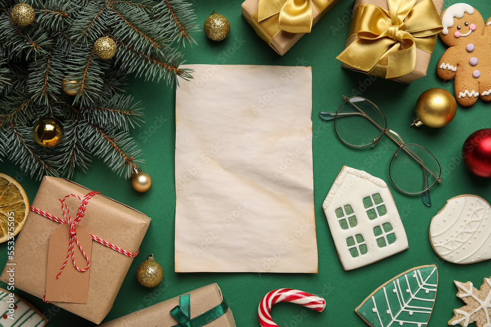 Blank letter to Santa with eyeglasses, cookies and Christmas decor on green background