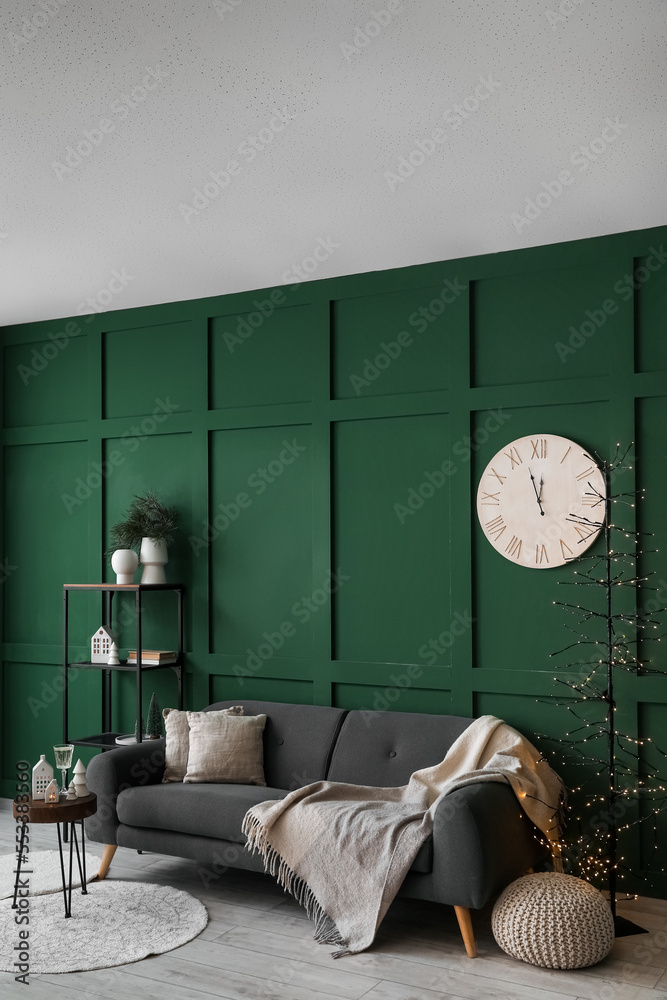 Interior of living room with candle holders, sofa and shelving unit