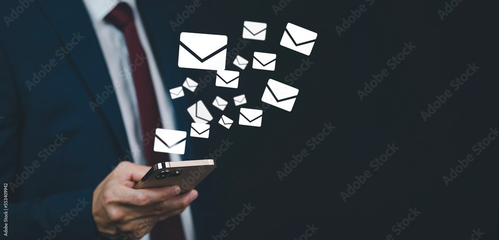 Businessmen holding smartphones with communication icons, letter icons, email icons, and newsletter 