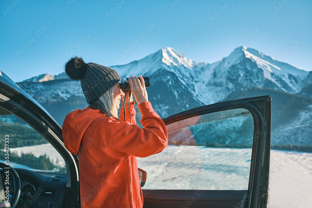 Woman traveling exploring, enjoying the view of the mountains, landscape, lifestyle concept winter v