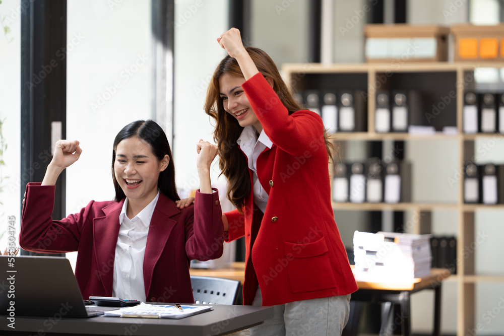 Excited concept, Happy young woman high fiving with colleague in office.