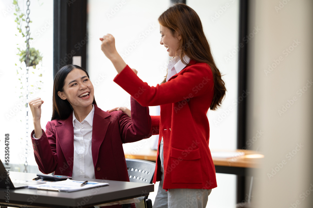 Excited concept, Happy young woman high fiving with colleague in office.