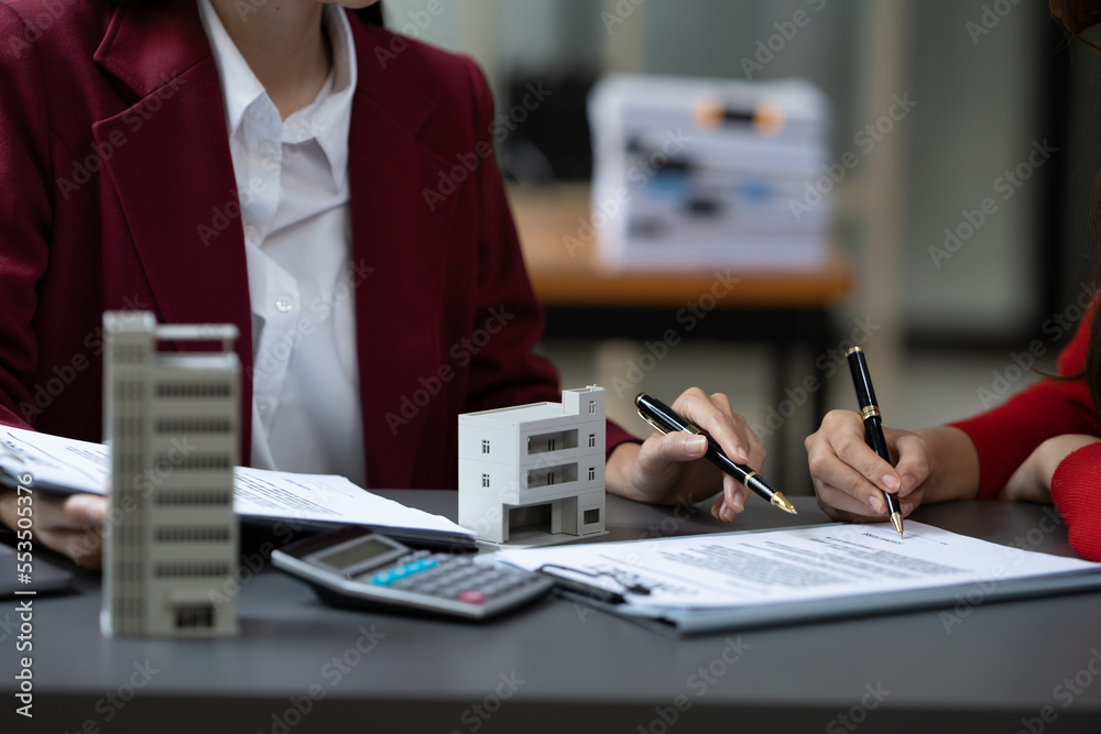 Asian businesswoman making a deal to buy a house or condo inside the office, home insurance concept