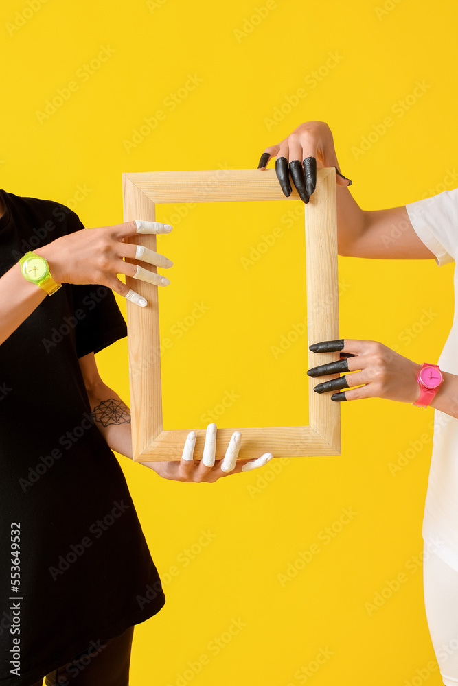 Female hands with frame on color background