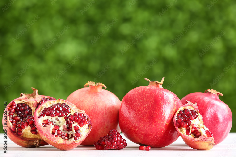 Fresh pomegranates on table outdoors