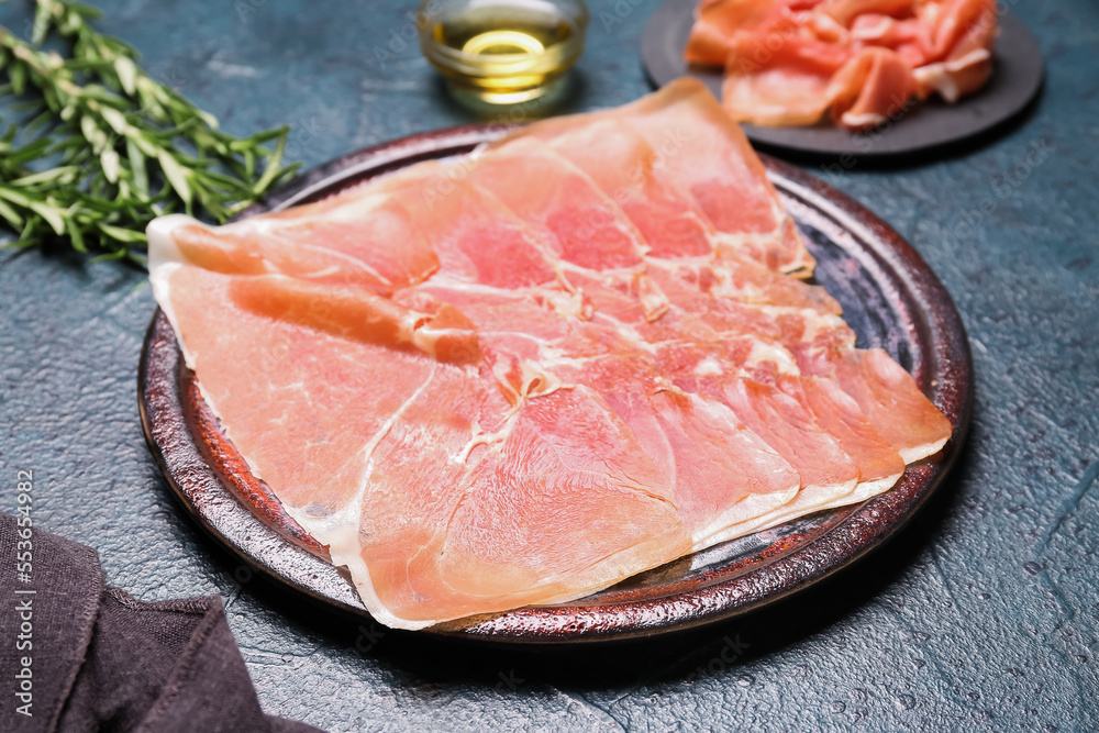 Plate with slices of tasty ham on dark color background, closeup