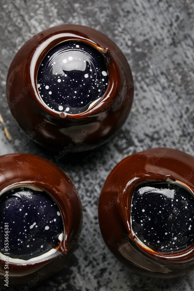 Chocolate candies on dark wooden board, closeup