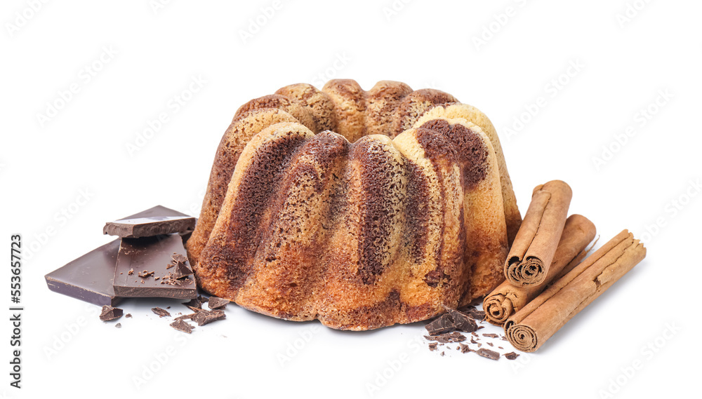 Delicious cake with cinnamon and chocolate on white background