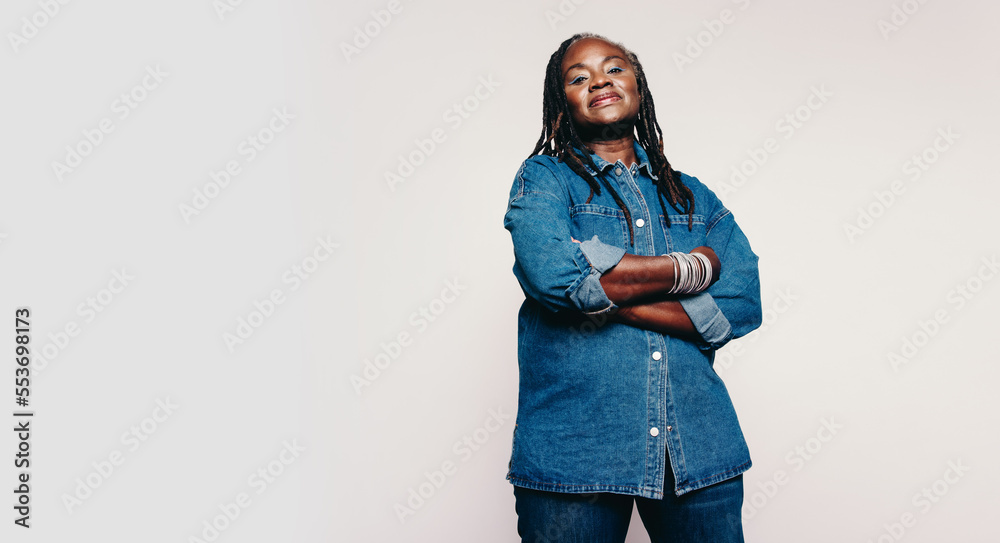 Fashionable woman with dreadlocks looking at the camera in a studio