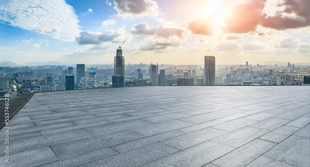 Empty square floor and modern city skyline with buildings at sunset in Ningbo, Zhejiang Province, Ch