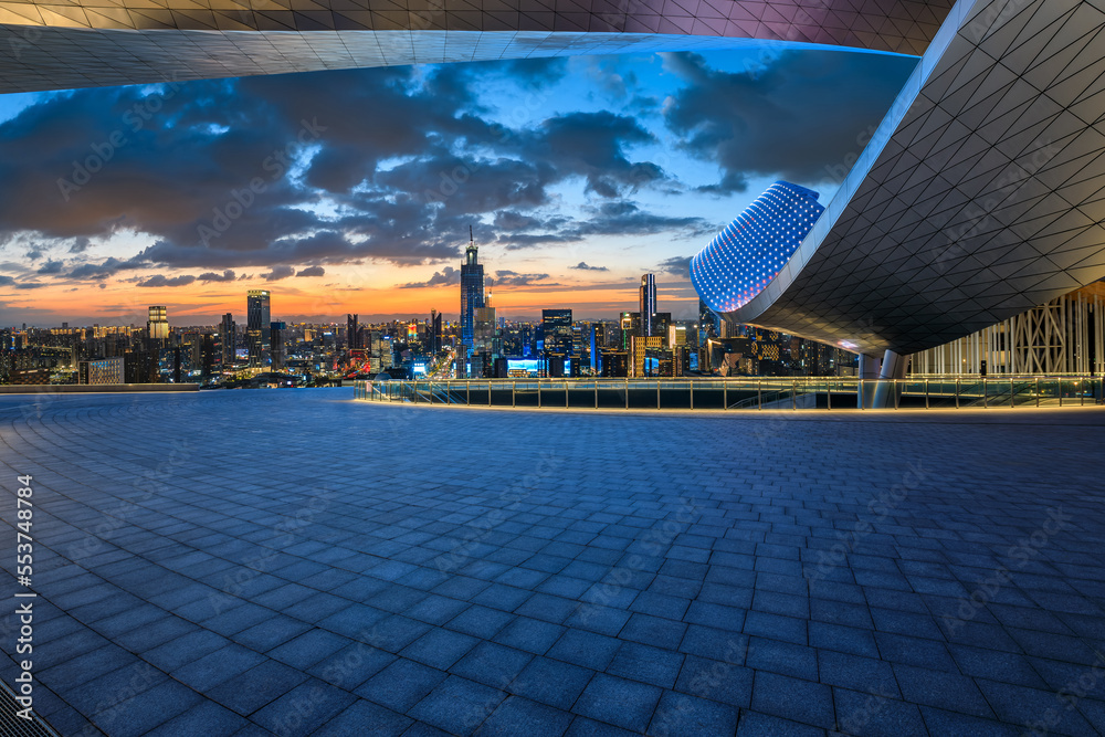 Empty square floor and modern city skyline with buildings at night in Ningbo, Zhejiang Province, Chi