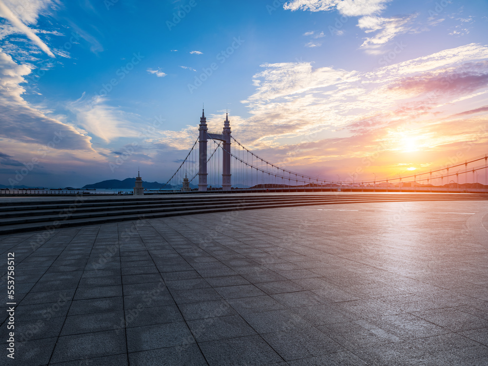 Empty square floors and bridge scenery at sunset in Zhoushan, Zhejiang, China.