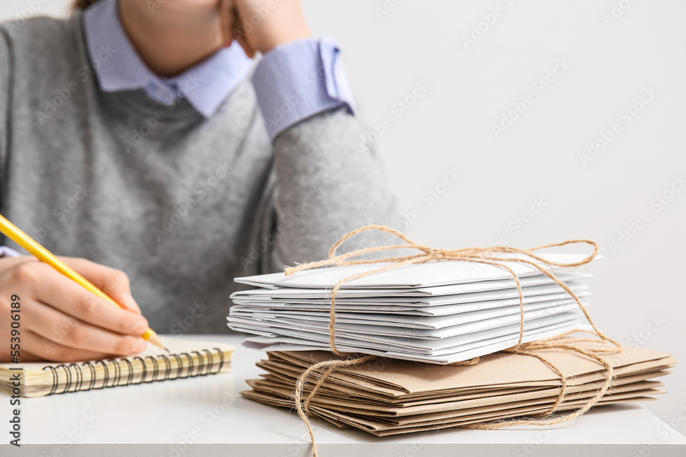 Stack of tied letters on table, closeup. Mail concept