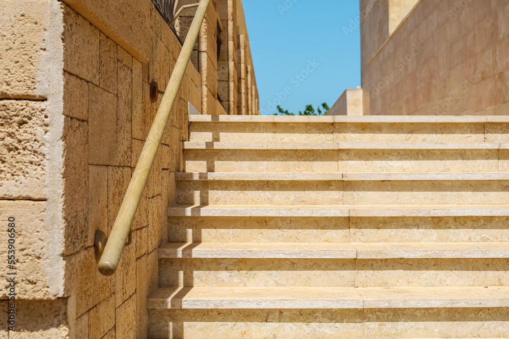 View of stone steps with railing in city