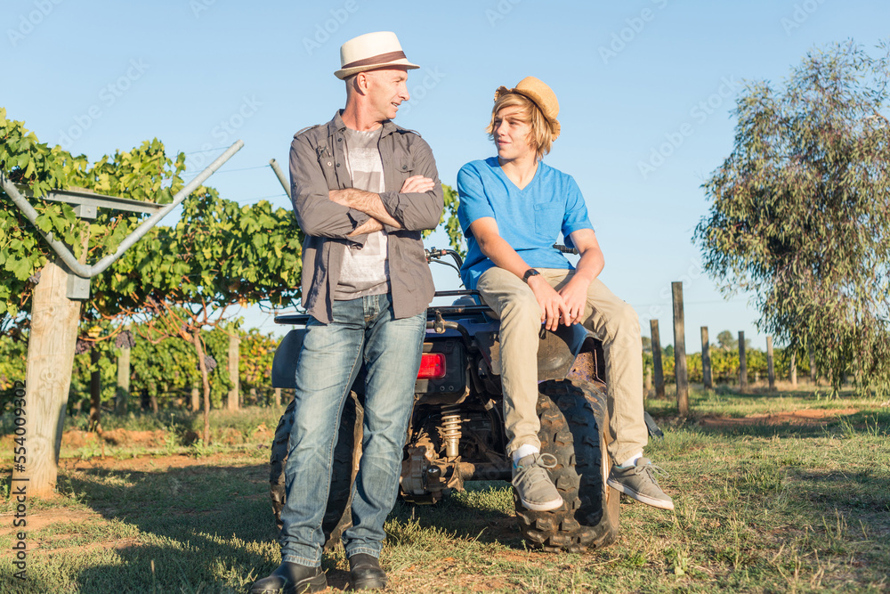 Man with arms folded speaking with guy