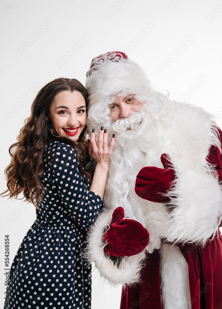 Man in costume of santa claus and beautiful girl on white background. Woman with santa claus togethe